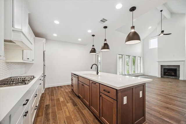 17471 Bayflower, Conroe, TX 77385 - kitchen featuring appliances with stainless steel finishes, white cabinetry, decorative backsplash, light countertops, and dark wood-type flooring