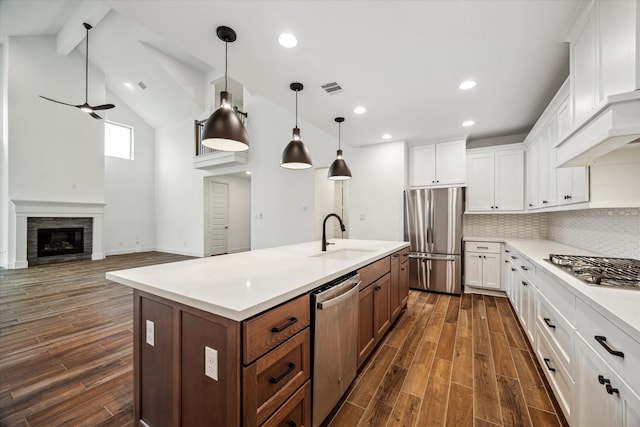 17471 Bayflower, Conroe, TX 77385 - kitchen featuring appliances with stainless steel finishes, dark wood-style flooring, white cabinetry, light countertops, and recessed lighting