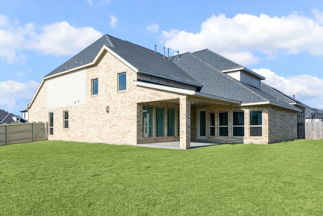 17471 Bayflower, Conroe, TX 77385 - rear view of house with brick siding, a patio area, a shingled roof, and a fenced backyard