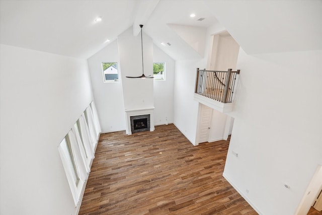 17471 Bayflower, Conroe, TX 77385 - unfurnished living room with wood finished floors, a fireplace, vaulted ceiling, and recessed lighting