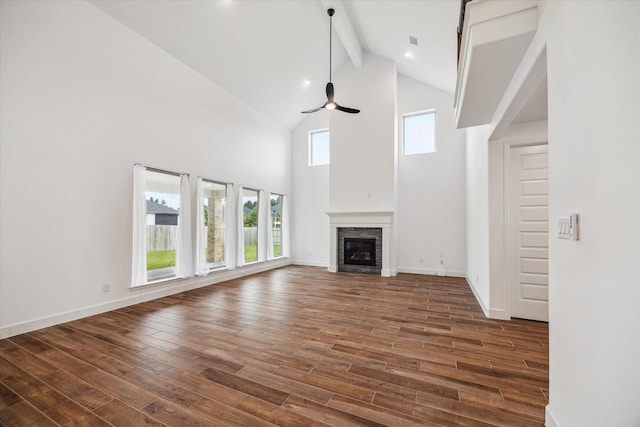 17471 Bayflower, Conroe, TX 77385 - unfurnished living room featuring beamed ceiling, high vaulted ceiling, a ceiling fan, dark wood-style flooring, and a fireplace