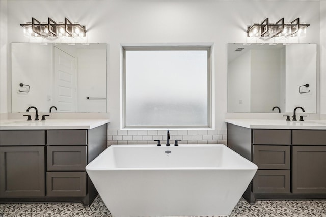 17471 Bayflower, Conroe, TX 77385 - bathroom with a soaking tub, two vanities, and tile patterned floors