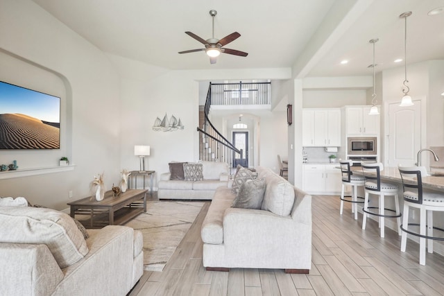 29446 Westhope Dr, Spring, TX 77386 - living area featuring stairs, a ceiling fan, light wood-type flooring, and recessed lighting