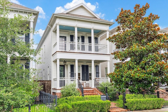 339 W 16th St, Houston, TX 77008 - view of front facade featuring covered porch, a balcony, a fenced front yard, and a gate