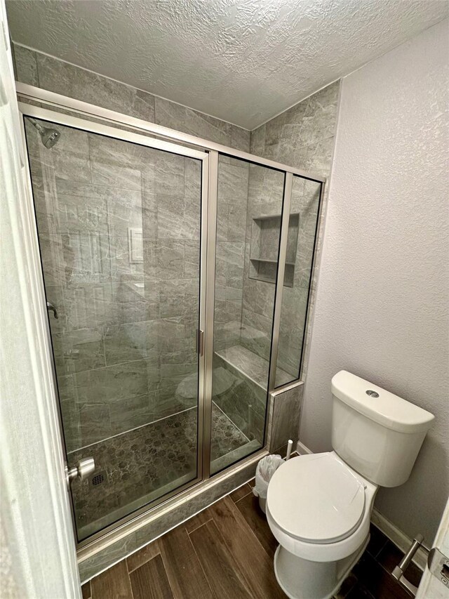 7254 Sonnet Glen Ln, Houston, TX 77095 - full bathroom with a stall shower, wood finished floors, and a textured ceiling