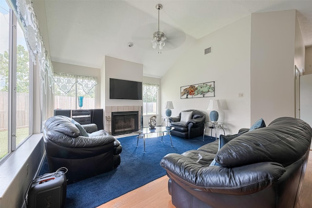 7838 Poitiers Dr, Houston, TX 77071 - living room with a ceiling fan, wood finished floors, vaulted ceiling, and a tile fireplace