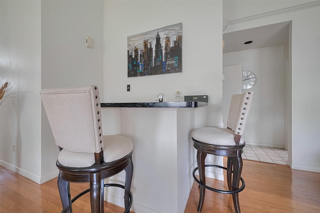 7838 Poitiers Dr, Houston, TX 77071 - indoor wet bar featuring light wood-type flooring and baseboards