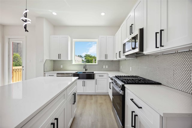 3210 Retta St A-B, Unit A-B Houston, TX 77026 - kitchen with stainless steel appliances, white cabinets, light wood-type flooring, backsplash, and recessed lighting