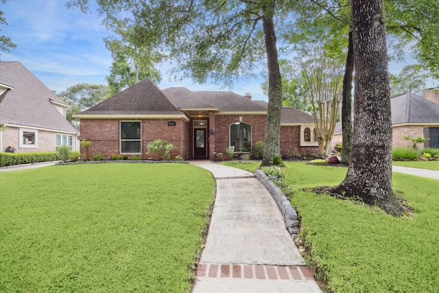 4331 Haven Glen Dr, Houston, TX 77339 - ranch-style house with a front yard, brick siding, roof with shingles, and a chimney