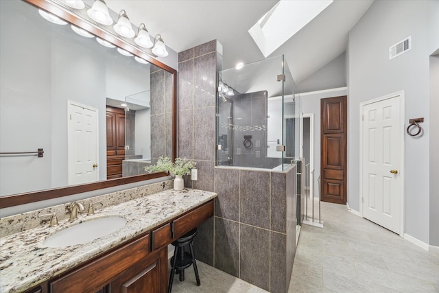 4331 Haven Glen Dr, Houston, TX 77339 - full bathroom with a shower stall, a skylight, vanity, high vaulted ceiling, and tile patterned flooring