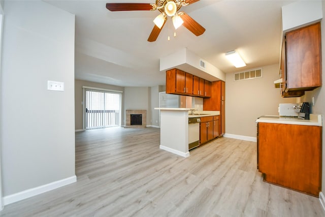 12905 Woodforest Blvd Unit 202, Houston, TX 77015 - kitchen featuring brown cabinetry, dishwasher, light countertops, and light wood-style flooring