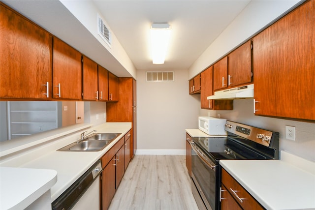 12905 Woodforest Blvd Unit 202, Houston, TX 77015 - kitchen featuring white appliances, under cabinet range hood, light countertops, and light wood-style flooring