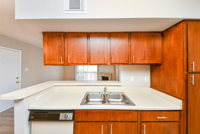 12905 Woodforest Blvd Unit 202, Houston, TX 77015 - kitchen featuring white dishwasher, light countertops, and brown cabinets
