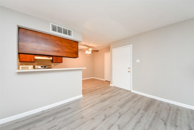 12905 Woodforest Blvd Unit 202, Houston, TX 77015 - unfurnished living room with light wood-style flooring and ceiling fan