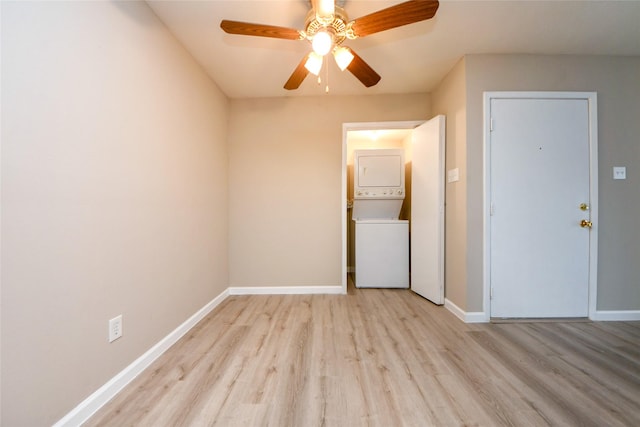 12905 Woodforest Blvd Unit 202, Houston, TX 77015 - empty room with stacked washer / dryer, wood finished floors, and a ceiling fan