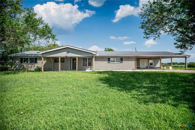 248 Park Rd, Port Lavaca, TX 77979 - view of front of property featuring a carport, a front lawn, and brick siding