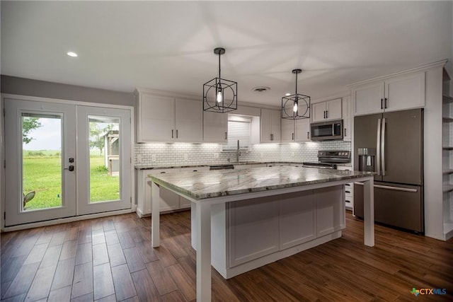 248 Park Rd, Port Lavaca, TX 77979 - kitchen featuring stainless steel appliances, white cabinets, french doors, a center island, and recessed lighting