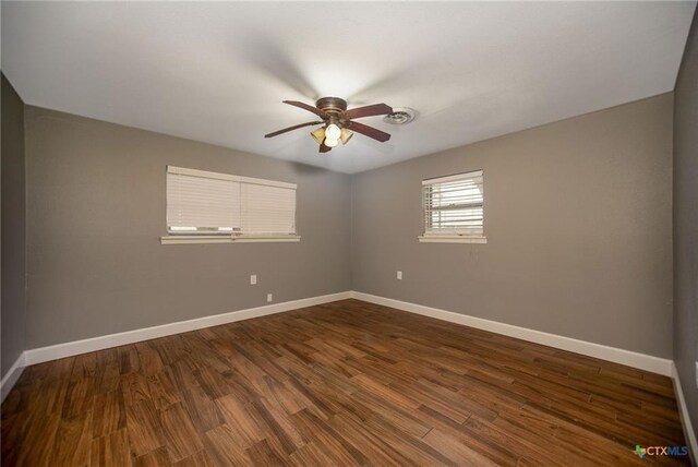 248 Park Rd, Port Lavaca, TX 77979 - empty room featuring a ceiling fan and dark wood finished floors