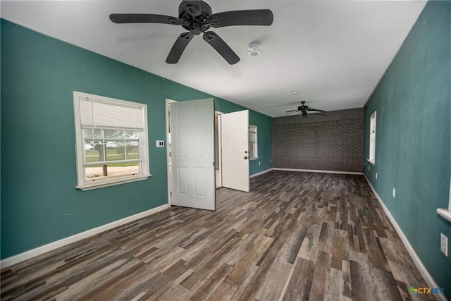 248 Park Rd, Port Lavaca, TX 77979 - unfurnished living room featuring ceiling fan, wood finished floors, vaulted ceiling, and an accent wall