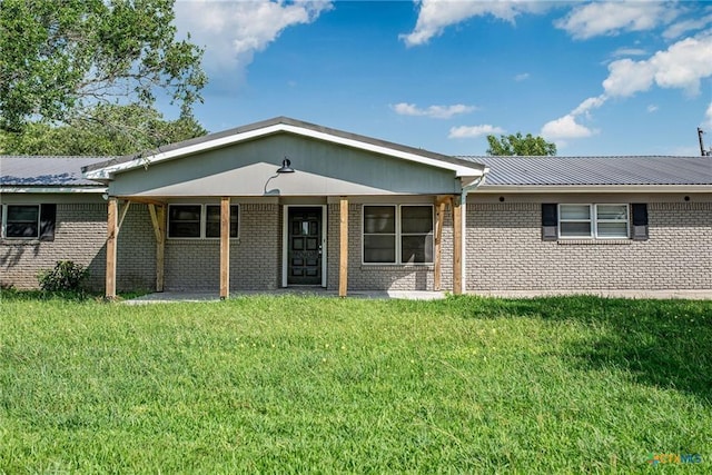 248 Park Rd, Port Lavaca, TX 77979 - ranch-style house featuring brick siding, a metal roof, and a front yard
