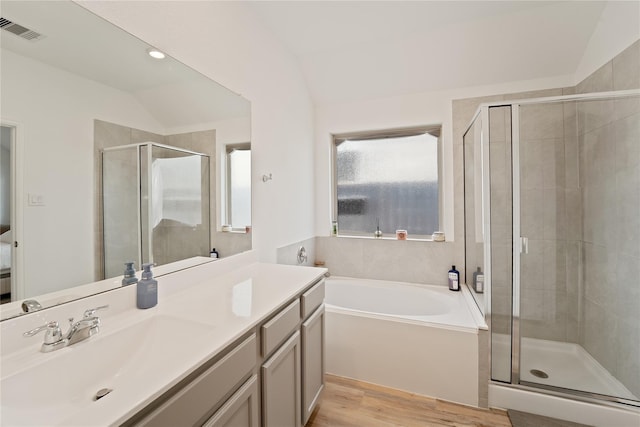 18471 Running Shadow Ct, Hockley, TX 77447 - bathroom with vaulted ceiling, vanity, a stall shower, a bath, and wood finished floors