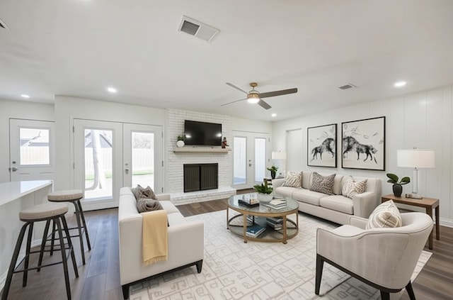 52 Oyster Creek Ct, Lake Jackson, TX 77566 - living room featuring wood finished floors, a brick fireplace, recessed lighting, ceiling fan, and french doors