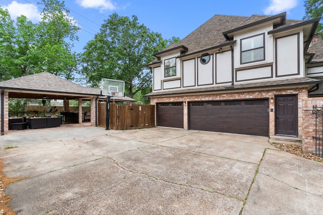 8706 Ashridge Park Dr, Spring, TX 77379 - view of side of home featuring a shingled roof, concrete driveway, an attached garage, a gazebo, and brick siding
