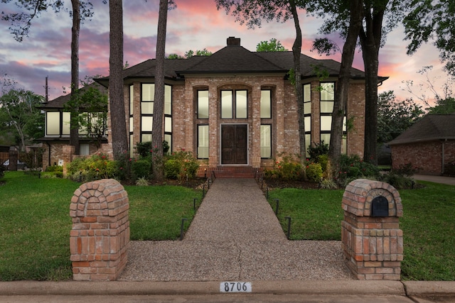 8706 Ashridge Park Dr, Spring, TX 77379 - view of front facade featuring brick siding, a yard, a chimney, and roof with shingles