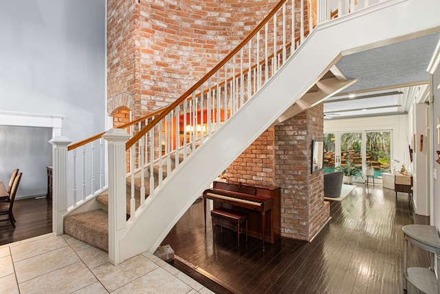 8706 Ashridge Park Dr, Spring, TX 77379 - stairs with a high ceiling and hardwood / wood-style flooring