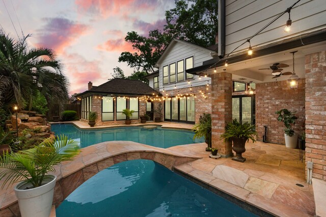 8706 Ashridge Park Dr, Spring, TX 77379 - pool at dusk with an outdoor pool and a patio area