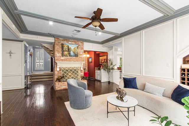 8706 Ashridge Park Dr, Spring, TX 77379 - living room with a decorative wall, ornamental molding, a brick fireplace, ceiling fan, and wood-type flooring