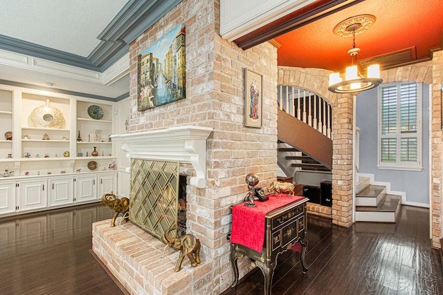 8706 Ashridge Park Dr, Spring, TX 77379 - living room with crown molding, a chandelier, dark wood-type flooring, built in features, and stairway