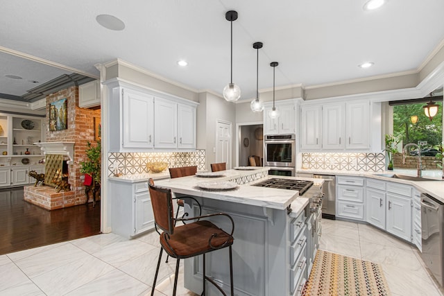 8706 Ashridge Park Dr, Spring, TX 77379 - kitchen with ornamental molding, a center island, stainless steel appliances, white cabinets, and a kitchen bar