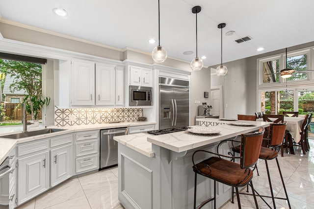 8706 Ashridge Park Dr, Spring, TX 77379 - kitchen featuring built in appliances, light marble finish flooring, a center island, plenty of natural light, and recessed lighting
