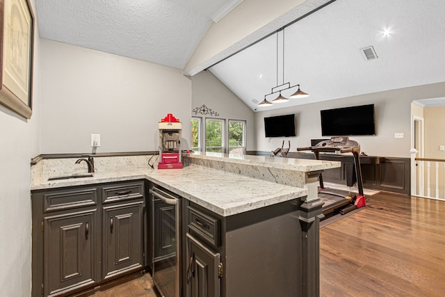 8706 Ashridge Park Dr, Spring, TX 77379 - kitchen featuring beverage cooler, dark wood-style floors, light stone countertops, a peninsula, and open floor plan