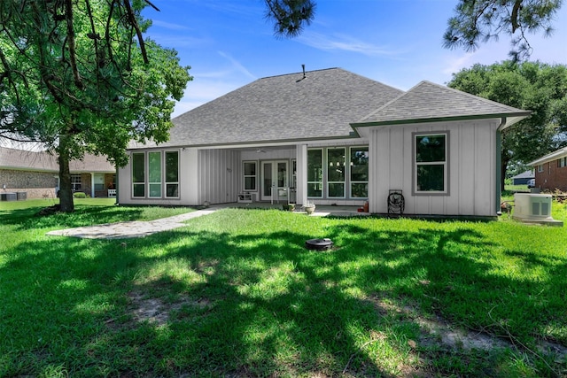 29 Westwood Dr W, Trinity, TX 75862 - back of house with roof with shingles, board and batten siding, a yard, and french doors