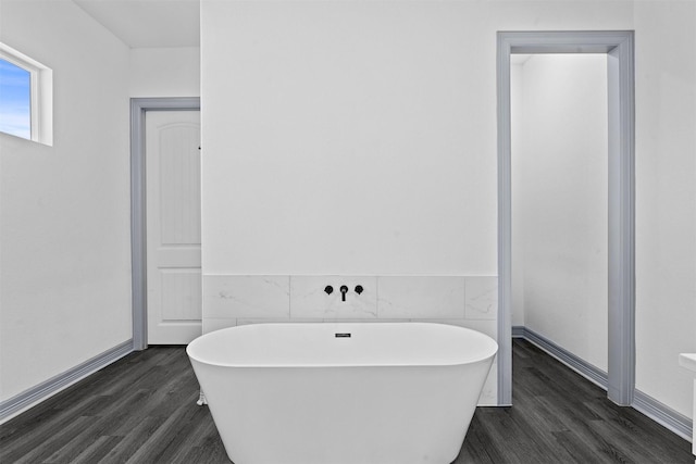 29 Westwood Dr W, Trinity, TX 75862 - bathroom with wood finished floors, a freestanding tub, and tile walls