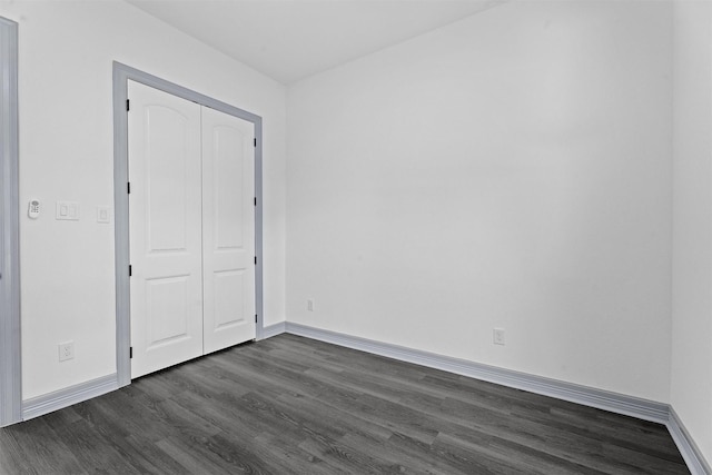 29 Westwood Dr W, Trinity, TX 75862 - unfurnished bedroom featuring dark wood-style flooring and a closet