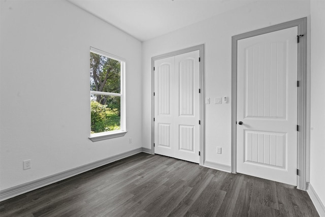 29 Westwood Dr W, Trinity, TX 75862 - unfurnished bedroom with dark wood-style floors and a closet