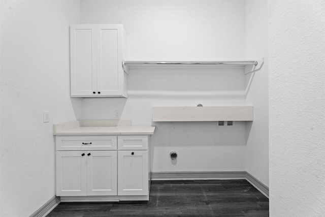 29 Westwood Dr W, Trinity, TX 75862 - laundry room featuring dark wood finished floors and cabinet space
