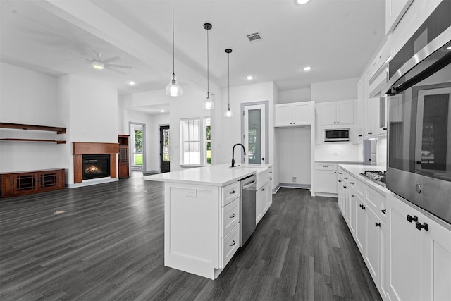 29 Westwood Dr W, Trinity, TX 75862 - kitchen with appliances with stainless steel finishes, dark wood-style floors, white cabinetry, a ceiling fan, and recessed lighting