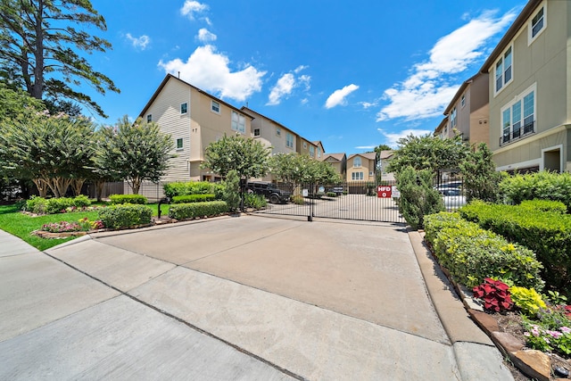878 Fisher St, Houston, TX 77018 - view of concrete street with a residential view, a gate, a gated entry, and curbs
