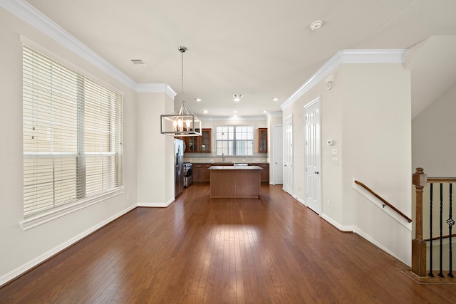 878 Fisher St, Houston, TX 77018 - kitchen featuring a center island, dark wood-type flooring, a chandelier, light countertops, and crown molding