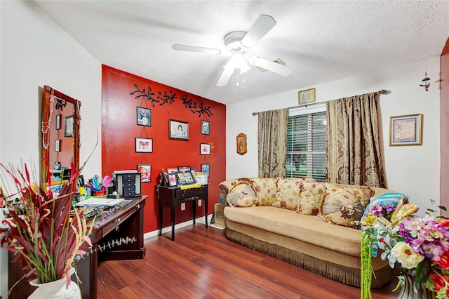 394 Sherandoe Ln, Alvin, TX 77511 - home office featuring dark wood finished floors, a ceiling fan, an accent wall, and a textured ceiling