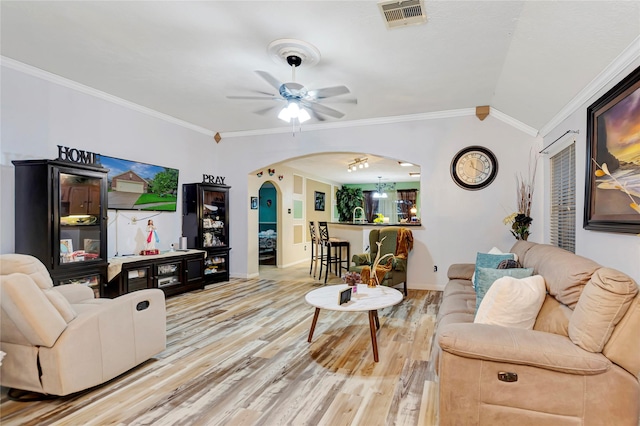394 Sherandoe Ln, Alvin, TX 77511 - living area with arched walkways, wood finished floors, crown molding, ceiling fan, and vaulted ceiling