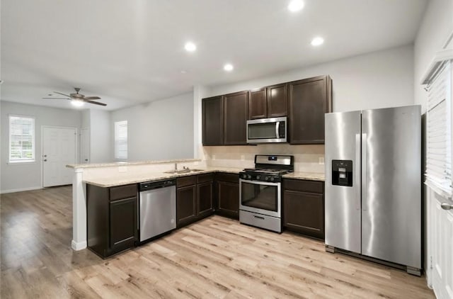 17531 Cuthbert St, Humble, TX 77346 - kitchen featuring stainless steel appliances, dark brown cabinetry, ceiling fan, light wood finished floors, and recessed lighting
