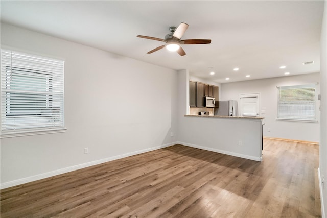 17531 Cuthbert St, Humble, TX 77346 - unfurnished living room with ceiling fan, light wood-type flooring, and recessed lighting