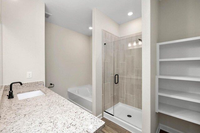 3032 Myrtle Sunset Dr, Katy, TX 77493 - bathroom with a garden tub, a stall shower, vanity, and wood finished floors