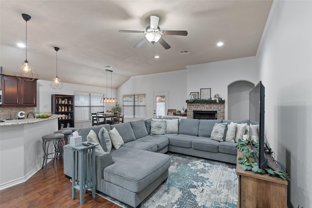 4202 Carnes Ct S, College Station, TX 77845 - living area with dark wood-style flooring, ceiling fan, lofted ceiling, and a brick fireplace