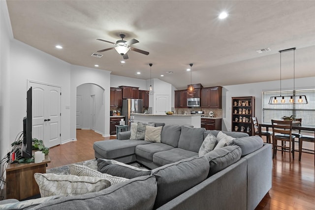 4202 Carnes Ct S, College Station, TX 77845 - living room featuring a ceiling fan, arched walkways, wood finished floors, and recessed lighting